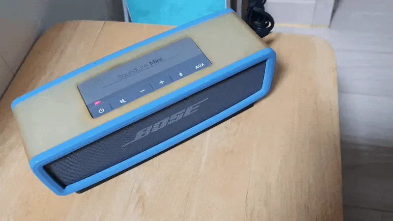 Bose SoundLink Mini 1 with red charging error light and yellowed silicone case Caption: The speaker that sat dead in a drawer for nearly a decade.