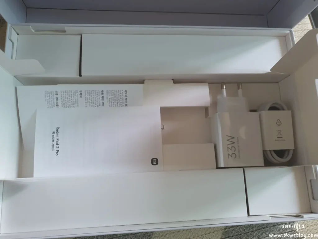Redmi Pad 2 Pro in-box contents including 33W charger, USB-C cable, and SIM ejector pin