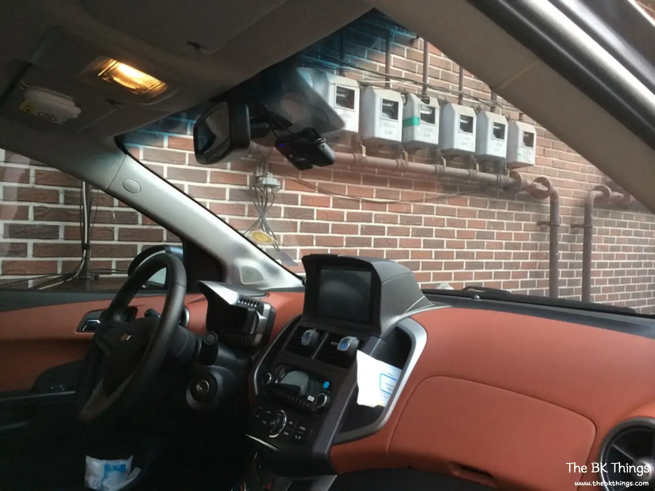 2013 Chevrolet Aveo / Sonic sedan interior with brick-brown dashboard trim