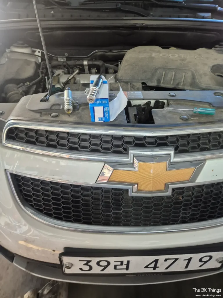 Mechanic replacing the LPG solenoid valve in a Chevrolet Orlando engine bay