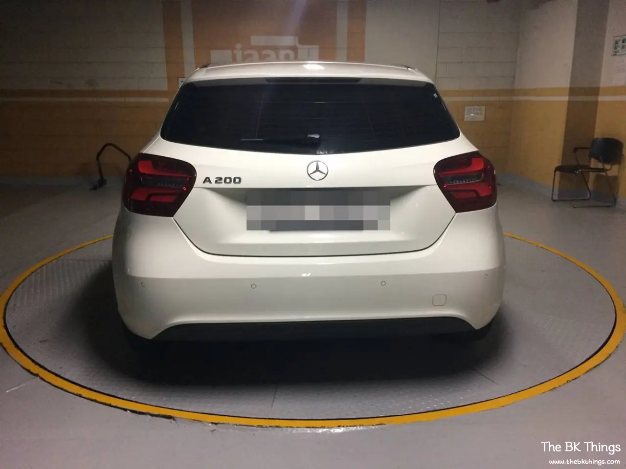Rear view of a white Mercedes-Benz A200 W176 on a parking turntable